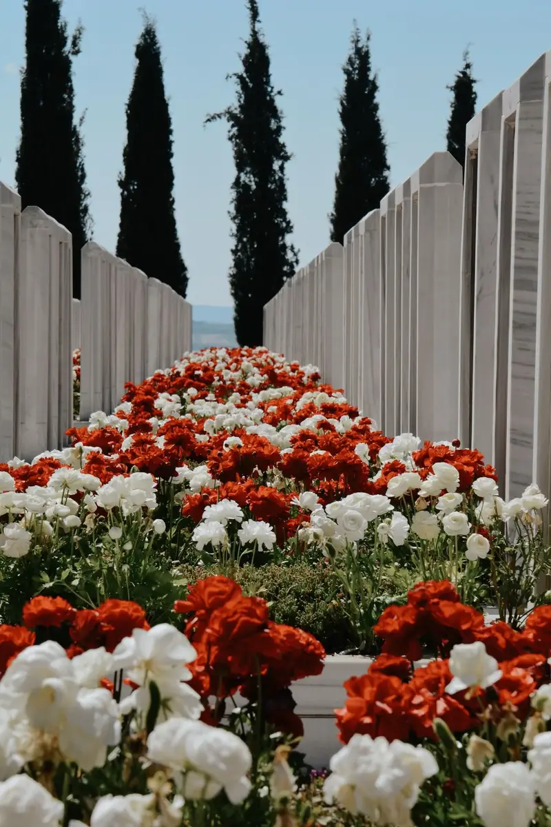 Embalmer pay with red and white memorial flowers