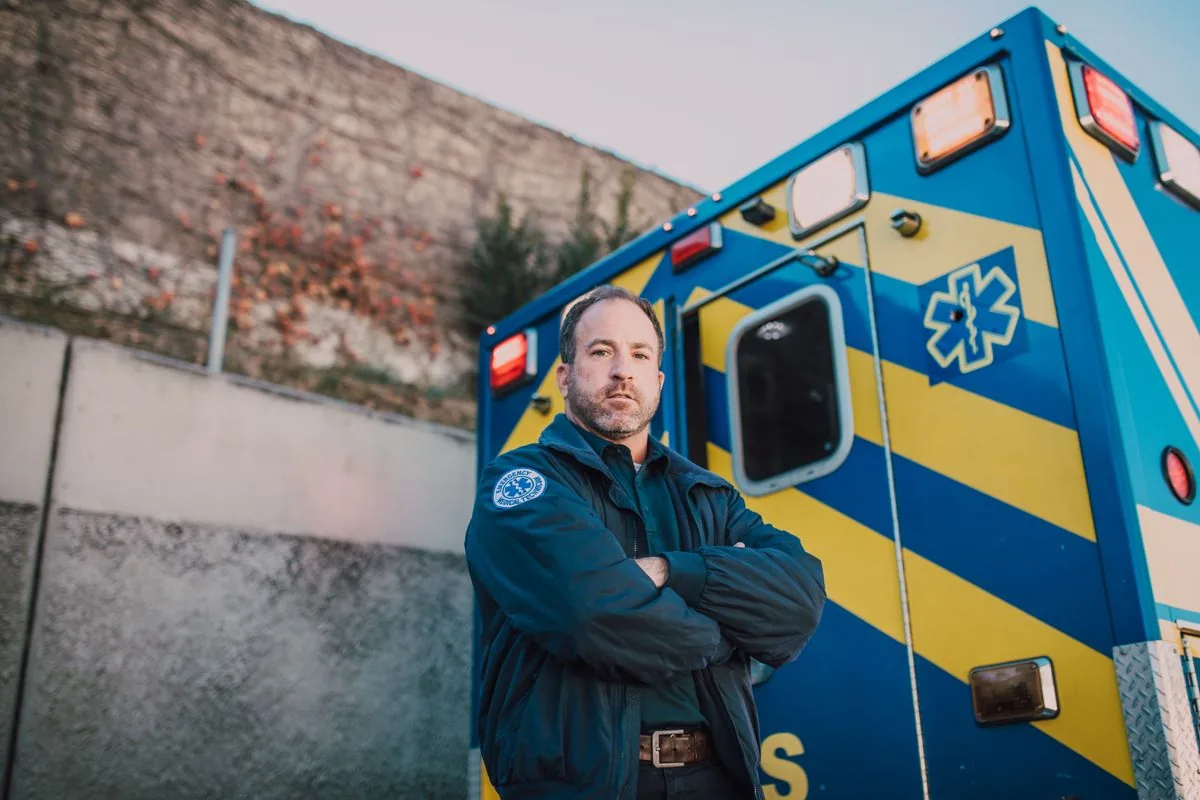 How much paramedics make with a paramedic beside an ambulance