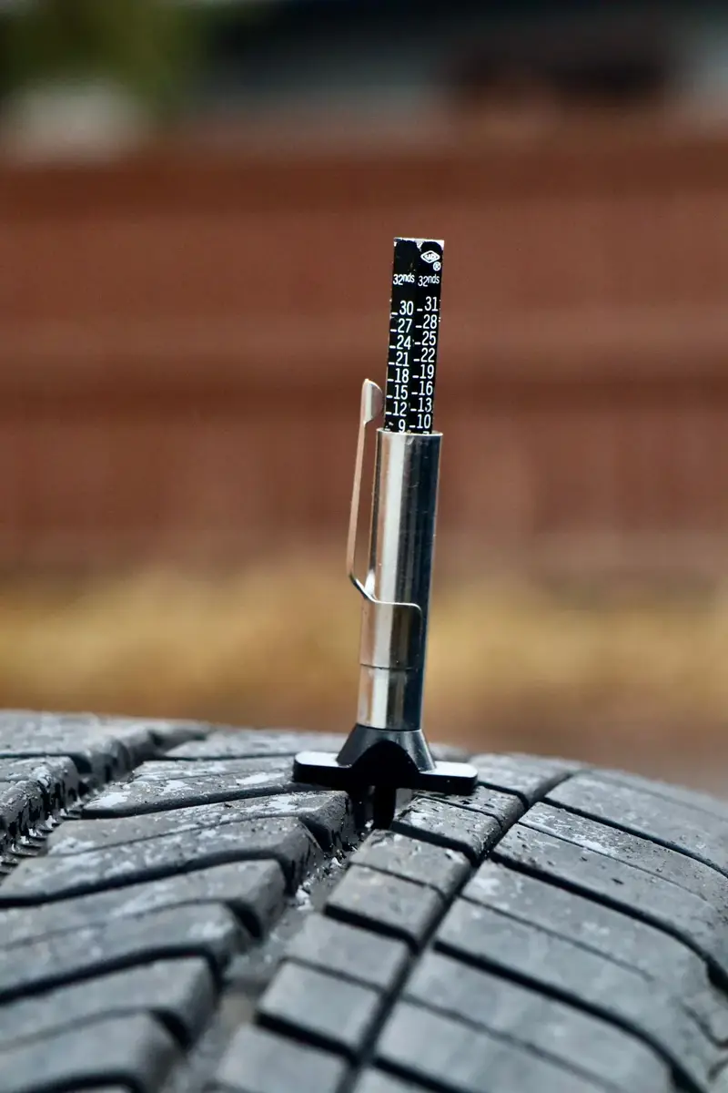 Learn to check tire tread depth with a probe gauge in the groove
