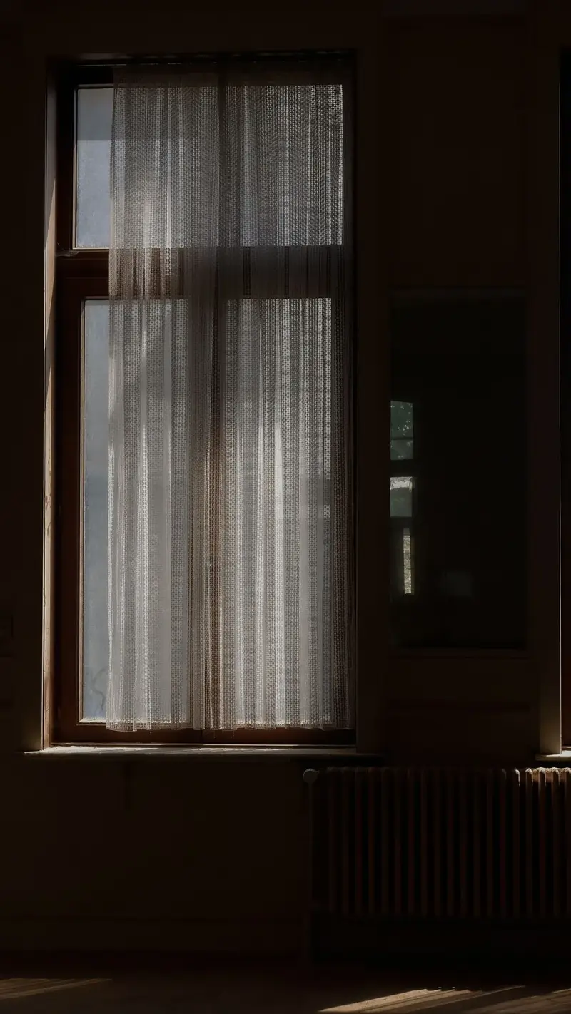 Sunlight through window curtains showing drop length to check when measuring