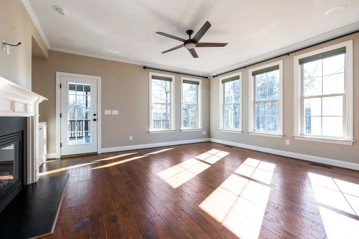 Empty living room with hardwood floors ready for taping furniture footprints