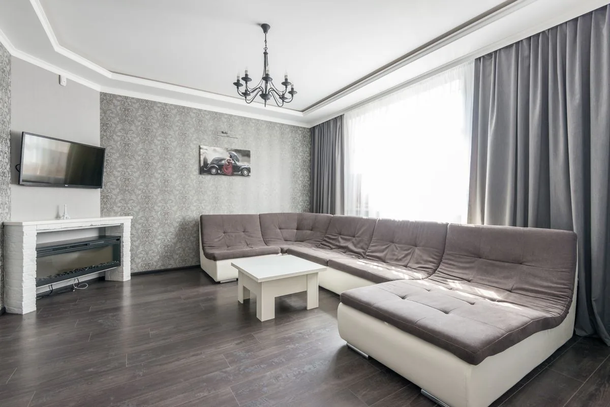Furnished living room showing delivered sofa fit checked against doorways