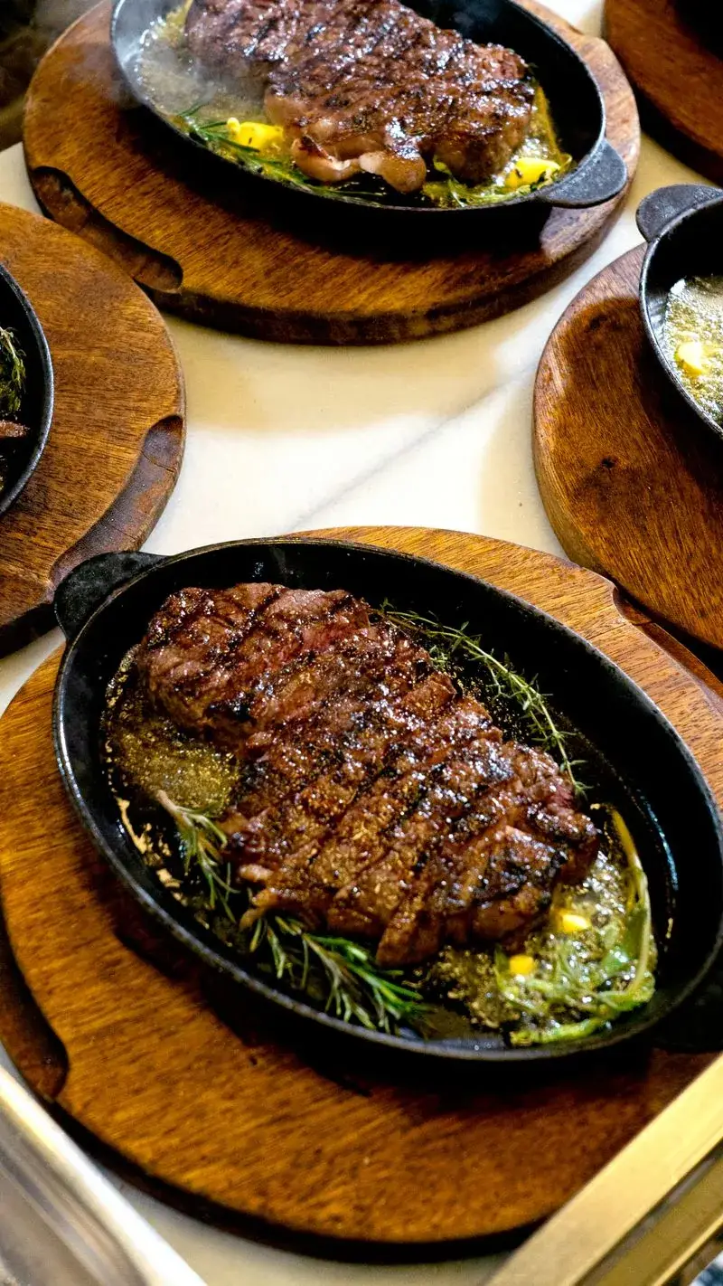 Sizzling steak in a restored cast iron skillet after rust removal