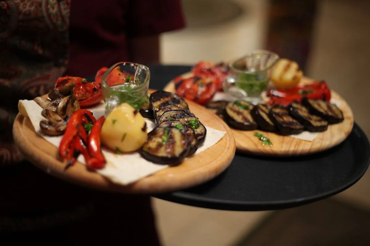 Roasted vegetables on a tray showing oven char for sweet peppers