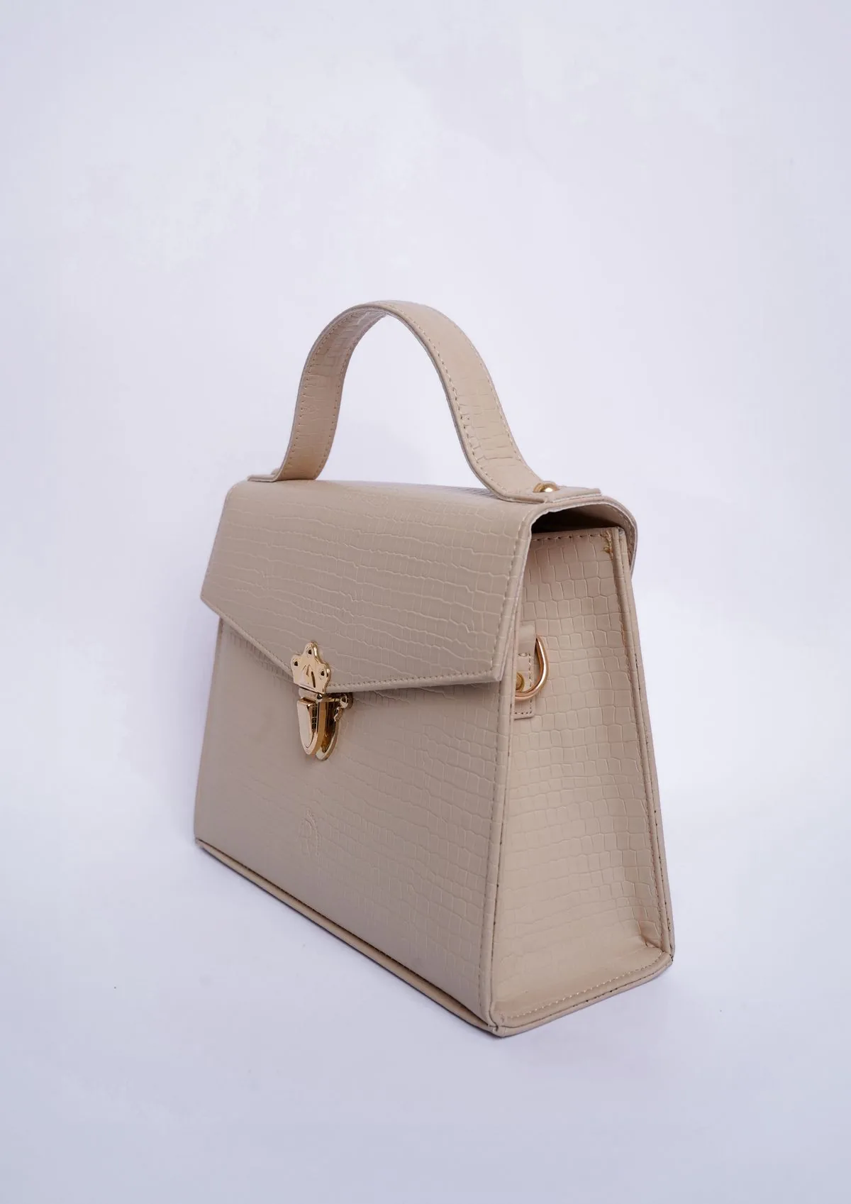Modern beige handbag photographed in a studio setting
