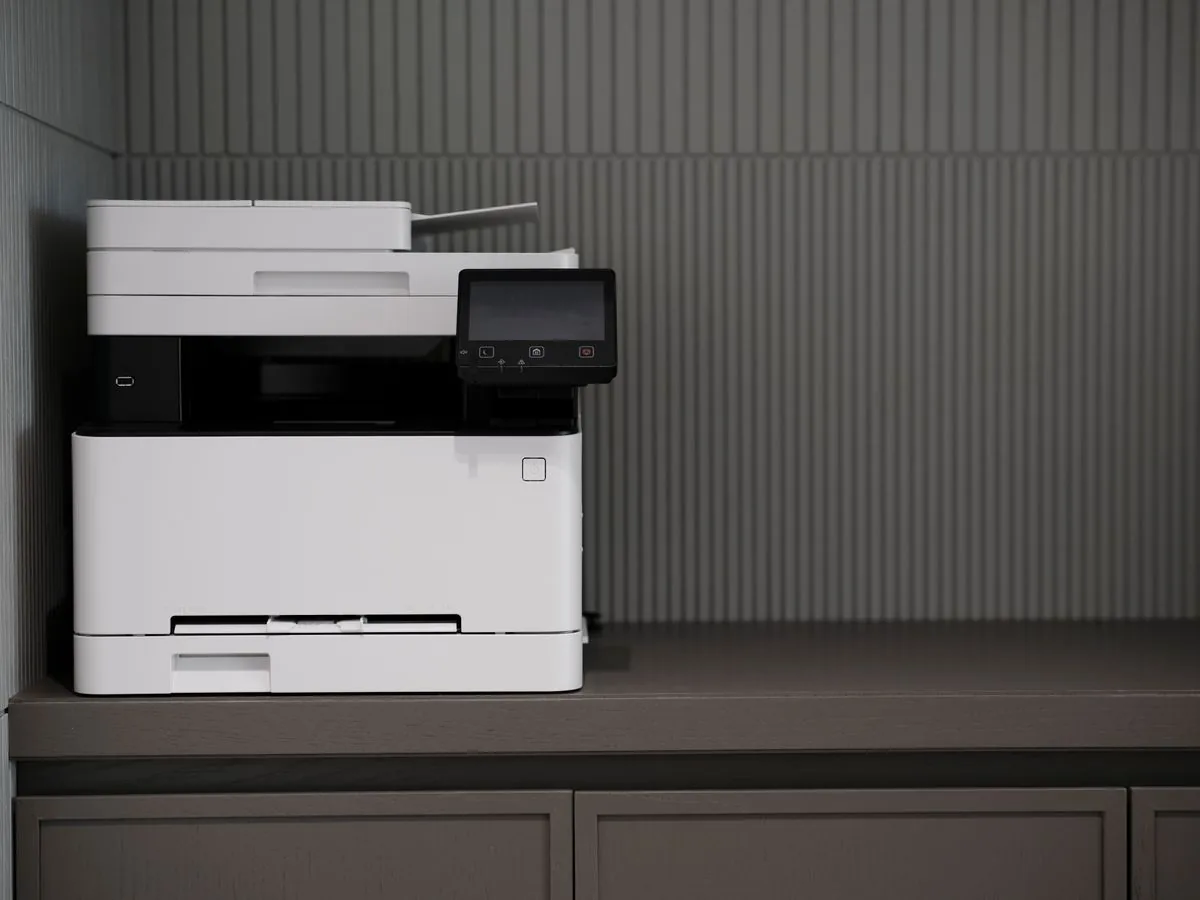 Modern office printer on a desk set up for collated multi-copy printing