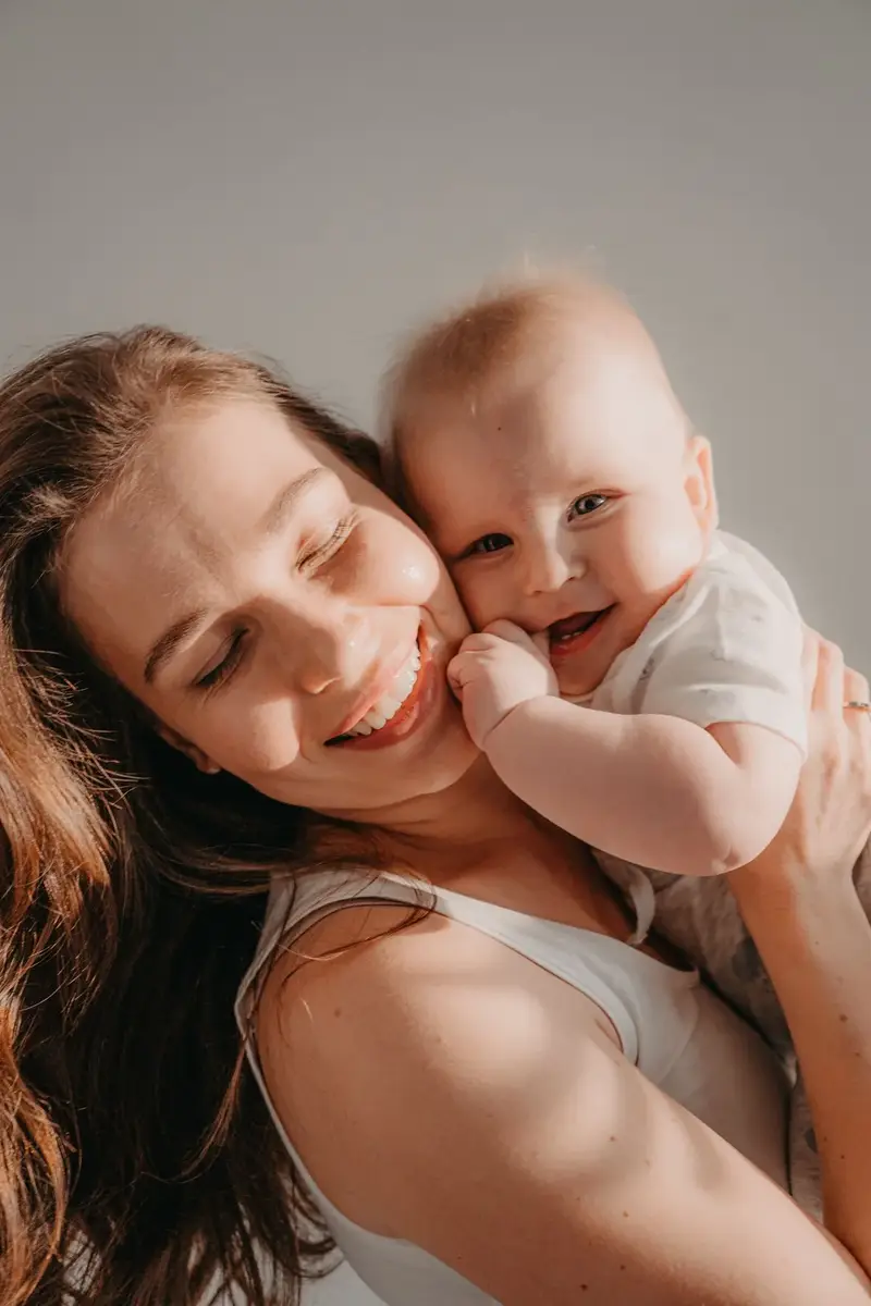 Baby chuckles and intentional smiles by four months in warm sunlight