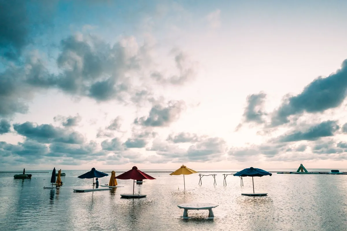 Sunrise parasols over calm San Pedro waters where is belize cayes base for reef days
