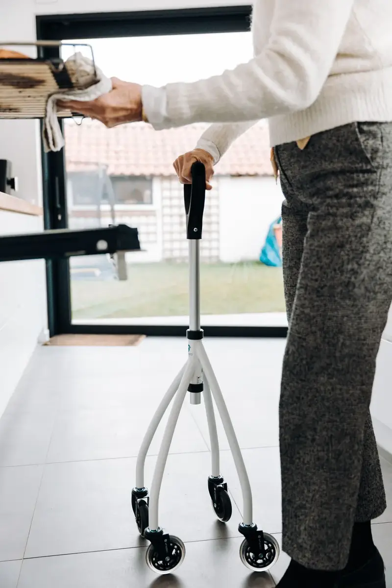 Elderly person using a walker indoors, cleaned and ready where to donate medical equipment
