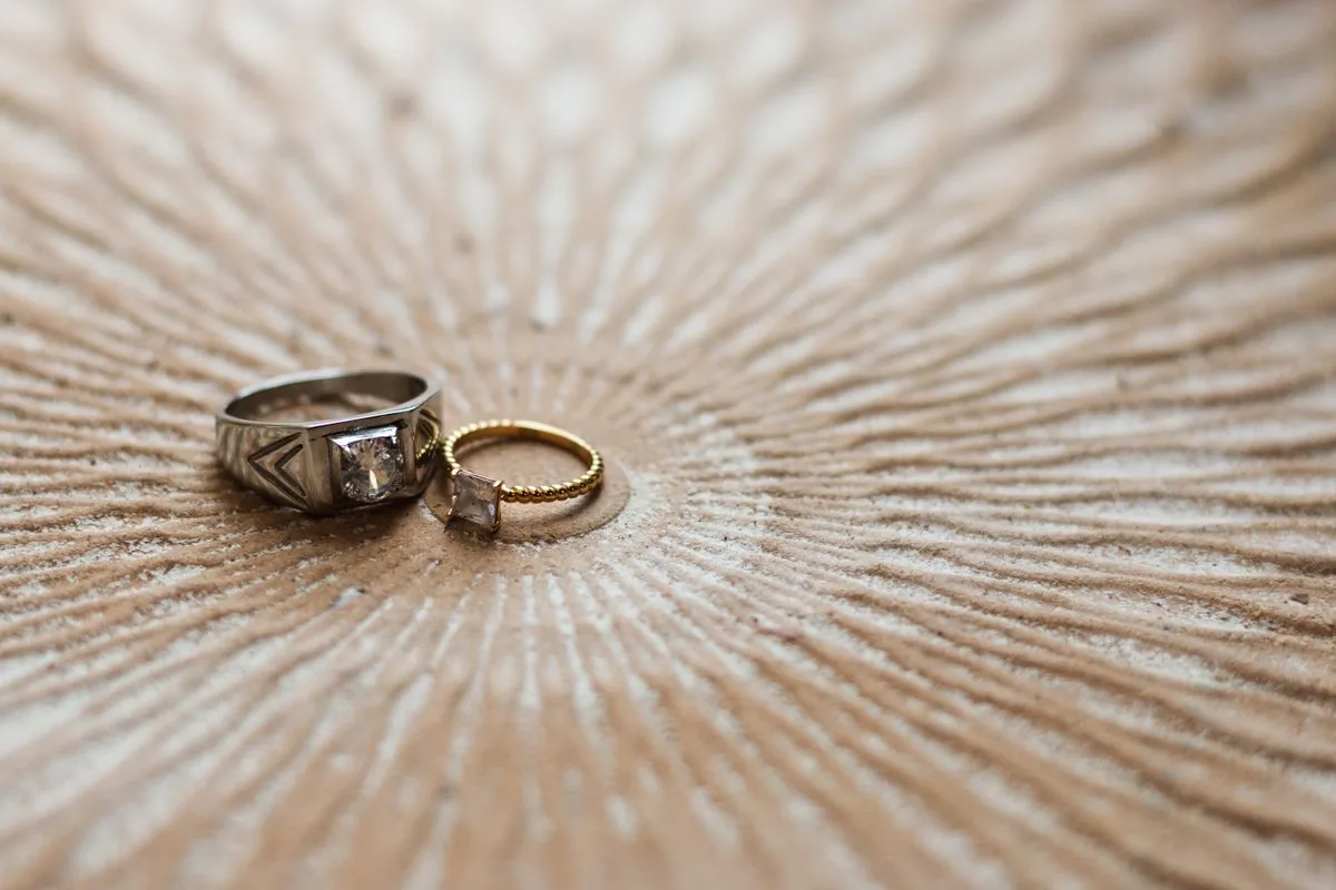 Silver and gold rings on textured surface prepped where to sell jewelry online with inventory photos