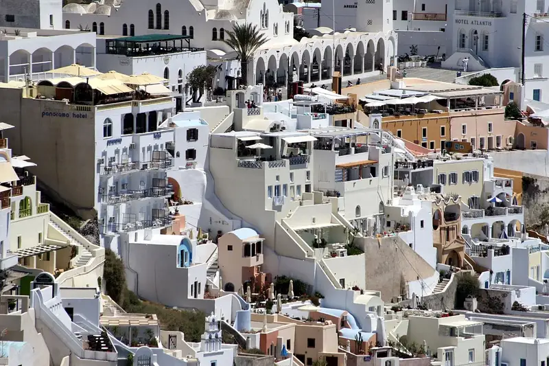 Fira Santorini whitewashed cliffs over the sea where to travel in summer for classic beaches